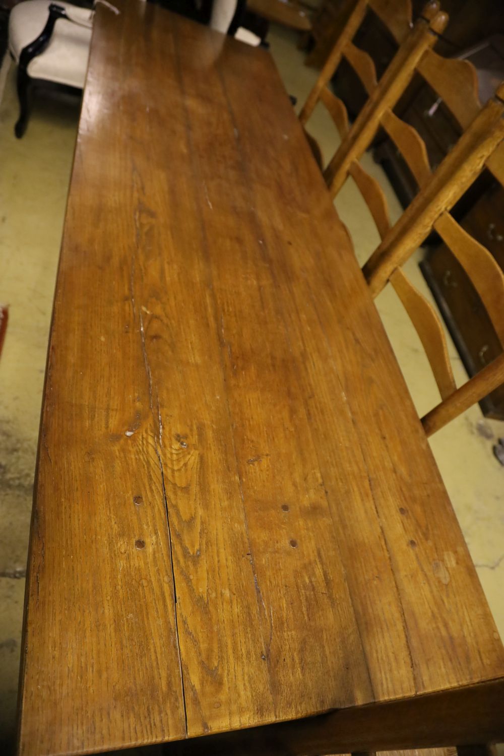 A 17th century style oak refectory table on X-frame supports, width 224cm, depth 70cm, height 74cm